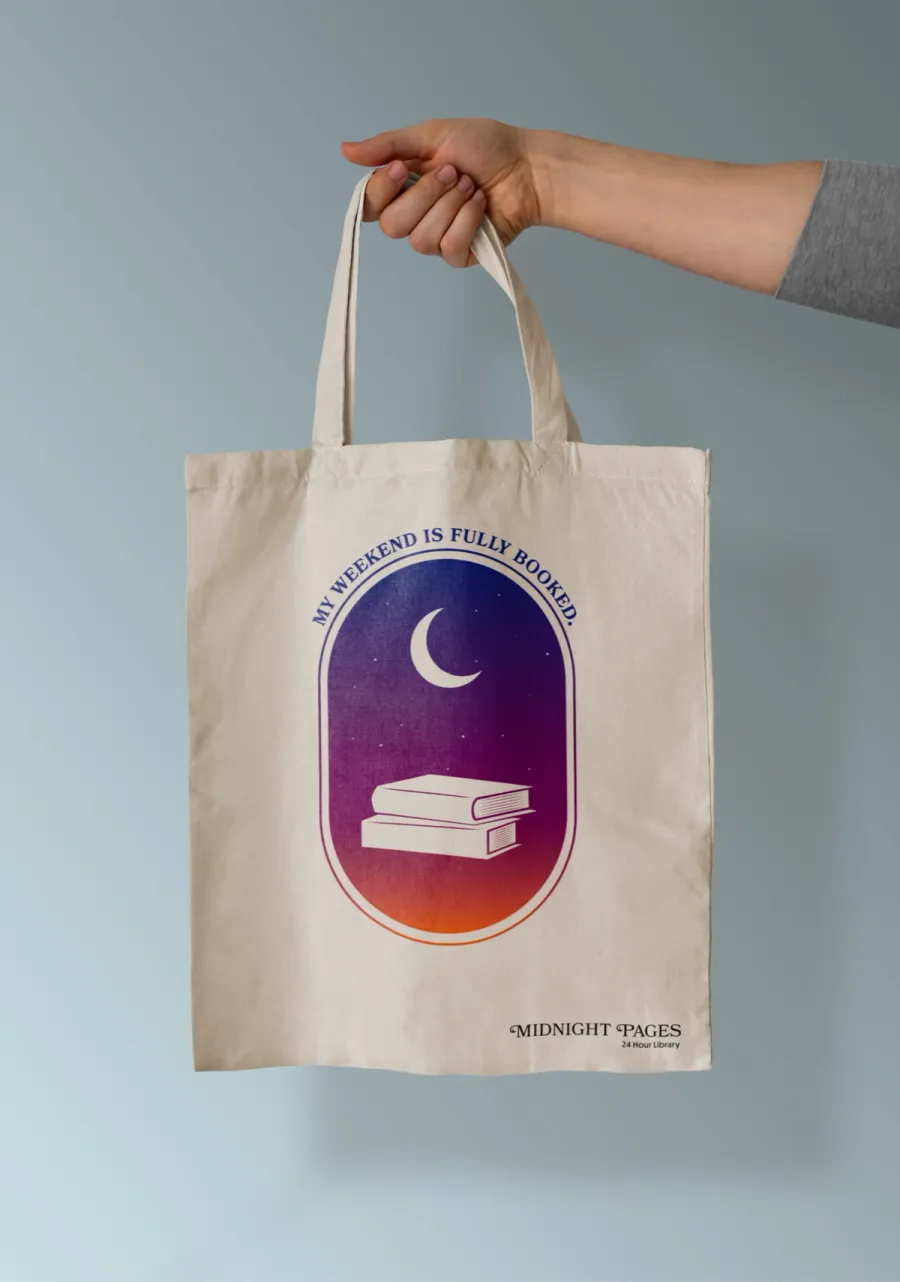 Mockup of a logo on a tote bag; the logo says "My weekend is fully booked" and shows an oval graphic of a moon and books, on a vibrant blue to orange gradient background.